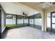 The screened-in patio features a ceiling fan, tile floors, and overlooks the private fenced backyard at 2729 Stanwood Dr, Kissimmee, FL 34743