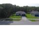 Wide aerial shot of a well-manicured, single story home with green lawn and paved driveway at 285 Marion Oaks Crse, Ocala, FL 34473