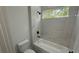 Bright bathroom featuring tub with tiled marble surround and black matte hardware at 285 Marion Oaks Crse, Ocala, FL 34473