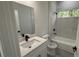 Bright bathroom featuring tub with tiled marble surround, granite counters and black matte hardware at 285 Marion Oaks Crse, Ocala, FL 34473