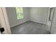 Light and airy bedroom featuring gray laminate flooring, white walls, and a window at 285 Marion Oaks Crse, Ocala, FL 34473