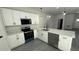 Bright kitchen with white cabinets, gray countertops, and stainless steel appliances at 285 Marion Oaks Crse, Ocala, FL 34473