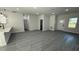 Open-concept living room with wood-look laminate flooring and white walls at 285 Marion Oaks Crse, Ocala, FL 34473