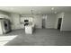 Open concept living area with gray laminate floors and white kitchen at 285 Marion Oaks Crse, Ocala, FL 34473
