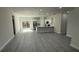 Modern living space with grey vinyl flooring, stainless steel appliances, and ample natural light at 285 Marion Oaks Crse, Ocala, FL 34473