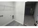 Functional utility room offering storage shelves, laundry hookups, and garage access for convenience at 285 Marion Oaks Crse, Ocala, FL 34473
