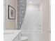 Clean bathroom with white subway tile and a modern black and white shower curtain at 3367 Vine Leaf St, Apopka, FL 32712