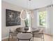 Cozy dining area features modern lighting, art, and backyard views at 3367 Vine Leaf St, Apopka, FL 32712