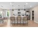 Bright, open kitchen with island seating, stainless appliances, and modern lighting fixtures at 3367 Vine Leaf St, Apopka, FL 32712