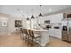 Modern kitchen with white cabinetry, stainless steel appliances, and a large island at 3367 Vine Leaf St, Apopka, FL 32712