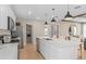 Modern kitchen features a spacious island, stainless steel appliances, and stylish pendant lighting at 3367 Vine Leaf St, Apopka, FL 32712