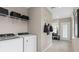 Well-equipped laundry room features modern appliances and shelving for storage at 3367 Vine Leaf St, Apopka, FL 32712