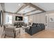 Bright living room with wooden beam ceilings, recessed lighting, and ample seating at 3367 Vine Leaf St, Apopka, FL 32712