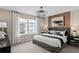 Stylish main bedroom features natural light, wood panel accent wall, and luxury finishes at 3367 Vine Leaf St, Apopka, FL 32712