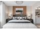 Stylish main bedroom features natural light, wood panel accent wall, and luxury finishes at 3367 Vine Leaf St, Apopka, FL 32712