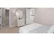 Well-lit bedroom boasts plush carpeting, a sleek dresser, and serene ambiance, perfect for unwinding after a long day at 3373 Orange Rose Loop, Apopka, FL 32712