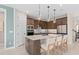 A spacious kitchen features stainless steel appliances, a center island with seating, and pendant lighting at 3373 Orange Rose Loop, Apopka, FL 32712