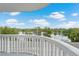 Balcony view overlooking lake and trees, with bright blue skies and puffy clouds at 400 E Colonial Dr # 207, Orlando, FL 32803