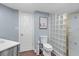 Bathroom features a toilet, wood floor, and glass block shower at 400 E Colonial Dr # 207, Orlando, FL 32803