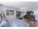 Bedroom features hardwood floors, sleek TV console, modern furniture, and a dedicated workspace at 400 E Colonial Dr # 207, Orlando, FL 32803