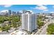 Beautiful white high-rise building in a vibrant urban setting with surrounding greenery and a glimpse of downtown at 400 E Colonial Dr # 207, Orlando, FL 32803