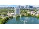 Elevated view featuring Park Lake Towers with lush landscaping and cityscape backdrop and a serene lake at 400 E Colonial Dr # 207, Orlando, FL 32803