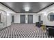 Elegant lobby area with elevator access, stylish seating, and unique geometric floor pattern at 400 E Colonial Dr # 207, Orlando, FL 32803