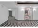 Well-lit hallway with a painting and patterned floor design, leading to residential units at 400 E Colonial Dr # 207, Orlando, FL 32803