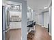 Modern kitchen with stainless steel appliances and breakfast bar seating, next to a hallway at 400 E Colonial Dr # 207, Orlando, FL 32803