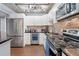 Modern kitchen with stainless steel appliances and sleek black countertops at 400 E Colonial Dr # 207, Orlando, FL 32803