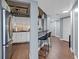 Modern kitchen with stainless steel appliances and breakfast bar seating, next to a hallway at 400 E Colonial Dr # 207, Orlando, FL 32803