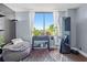 Bright, airy living room with a large window, plants, beanbag chair, and modern accents at 400 E Colonial Dr # 207, Orlando, FL 32803