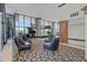 Elegant lobby features a grand piano, comfortable seating, high ceilings, and expansive windows offering ample natural light at 400 E Colonial Dr # 207, Orlando, FL 32803