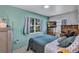 Cozy bedroom featuring a comfy bed, natural light from a large window and neutral colored walls at 405 Willow Ave, Sanford, FL 32771