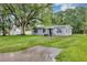 Well-maintained gray home with front yard, and landscaping at 405 Willow Ave, Sanford, FL 32771