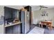 Kitchen space includes stainless refrigerator, dark wood cabinets, and small dining area at 405 Willow Ave, Sanford, FL 32771
