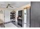 Kitchen area with stainless steel refrigerator, dark cabinets, and easy access to back door at 405 Willow Ave, Sanford, FL 32771