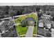 Aerial view of a well manicured home with a luscious green lawn and tall trees in the background at 4065 Shadowind Way, Gotha, FL 34734