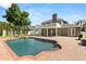 Backyard with pool, hot tub, brick pavers, outdoor seating, and a second-story deck at 4065 Shadowind Way, Gotha, FL 34734