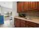 Wet bar featuring sleek sink, wine rack, and wooden cabinets with tile floors and a dining area just beyond at 4065 Shadowind Way, Gotha, FL 34734