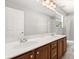 Bathroom features a double sink with wood cabinets, a large mirror and tiled flooring at 4065 Shadowind Way, Gotha, FL 34734