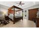 Spacious bedroom with a four-poster bed, wood floors, and french doors to the backyard at 4065 Shadowind Way, Gotha, FL 34734
