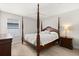 Classic bedroom features a four poster bed with wooden flooring, ceiling fan, and natural light at 4065 Shadowind Way, Gotha, FL 34734
