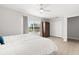 Spacious bedroom features an expansive window, plush carpet, and a ceiling fan at 4065 Shadowind Way, Gotha, FL 34734