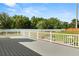 Spacious deck with a white railing offering views of the fenced backyard and pool area at 4065 Shadowind Way, Gotha, FL 34734