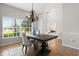 Dining room featuring a rustic table and chairs, enhanced by natural light and an elegant chandelier at 4065 Shadowind Way, Gotha, FL 34734