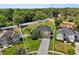 Exterior view of a beautiful home with manicured landscaping, a long driveway, and a two-car garage at 4065 Shadowind Way, Gotha, FL 34734