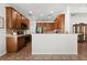 Open-concept kitchen offering modern appliances, wooden cabinets, and a spacious layout with bar seating at 4065 Shadowind Way, Gotha, FL 34734