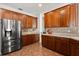 Well-equipped kitchen featuring stainless steel appliances, custom cabinets, and sleek countertops with tile backsplash at 4065 Shadowind Way, Gotha, FL 34734