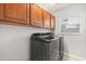Convenient laundry room equipped with side-by-side washer and dryer, plus overhead cabinet storage at 4065 Shadowind Way, Gotha, FL 34734
